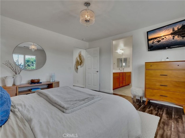 205 W Sparkleberry Ave, Orange, CA 92865 - bedroom featuring a chandelier, wood finished floors, and ensuite bath