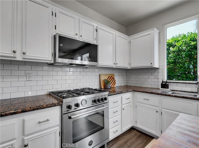 205 W Sparkleberry Ave, Orange, CA 92865 - kitchen with appliances with stainless steel finishes, white cabinetry, and dark stone countertops