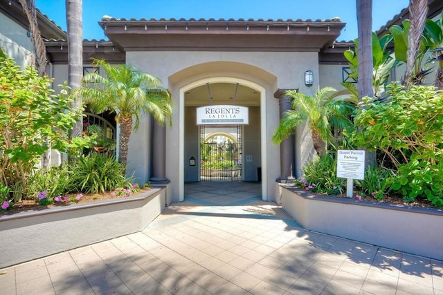 9263 Regents Rd Unit B106, La Jolla, CA 92037 - doorway to property with stucco siding and a gate