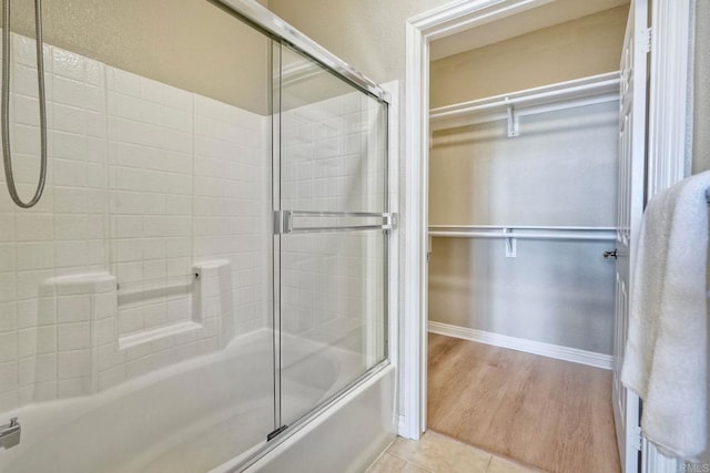9263 Regents Rd Unit B106, La Jolla, CA 92037 - bathroom with shower / bath combination with glass door, a walk in closet, and tile patterned floors