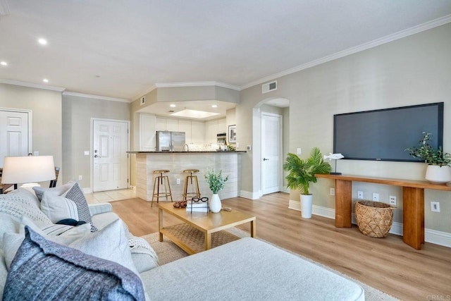 9263 Regents Rd Unit B106, La Jolla, CA 92037 - living area featuring light wood-style floors, recessed lighting, arched walkways, and crown molding
