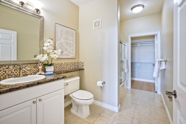 9263 Regents Rd Unit B106, La Jolla, CA 92037 - bathroom with tile patterned flooring, vanity, backsplash, and bath / shower combo with glass door