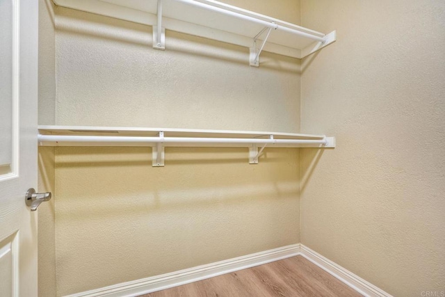 9263 Regents Rd Unit B106, La Jolla, CA 92037 - walk in closet featuring wood finished floors