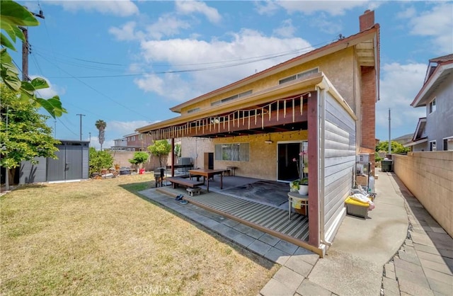 2033 W 169th Pl, Torrance, CA 90504 - back of house featuring a storage shed, a fenced backyard, a patio area, a chimney, and stucco siding