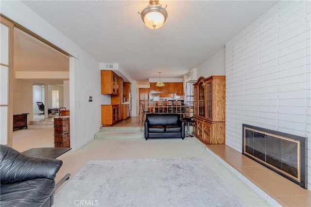 2033 W 169th Pl, Torrance, CA 90504 - living area featuring a large fireplace, light carpet, and a textured ceiling