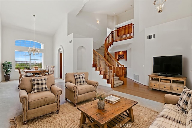 31794 Corte Rosario, Temecula, CA 92592 - living room featuring a high ceiling, a chandelier, stairs, light wood-style flooring, and arched walkways
