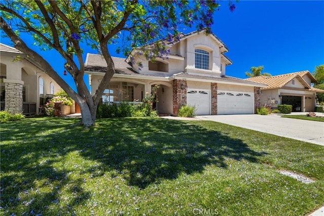 31794 Corte Rosario, Temecula, CA 92592 - view of front of property with stone siding, a front yard, stucco siding, a garage, and concrete driveway