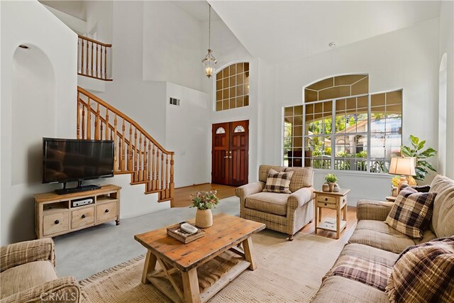 31794 Corte Rosario, Temecula, CA 92592 - living area featuring high vaulted ceiling, stairway, a chandelier, and arched walkways