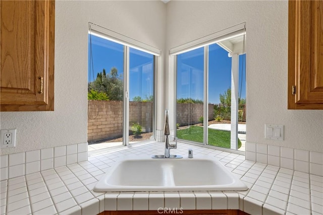 31794 Corte Rosario, Temecula, CA 92592 - kitchen featuring a textured wall, tile countertops, and brown cabinetry