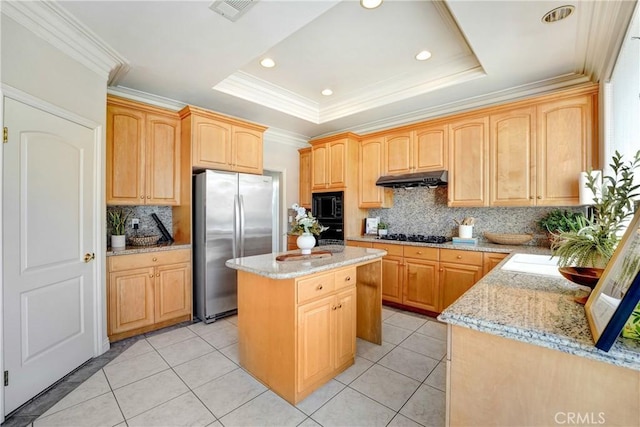 9103 Rancho Real Rd, Temple City, CA 91780 - kitchen featuring freestanding refrigerator, black microwave, light stone counters, under cabinet range hood, and tasteful backsplash