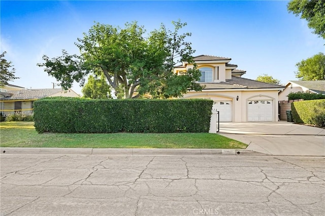 9103 Rancho Real Rd, Temple City, CA 91780 - mediterranean / spanish-style house with stucco siding, driveway, a tile roof, and an attached garage