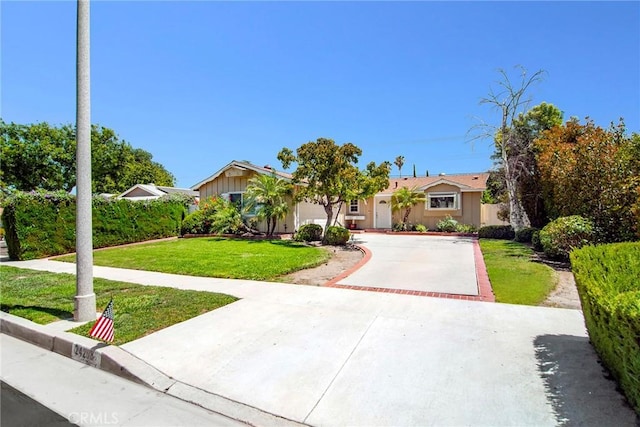 24208 Gilmore St, West Hills, CA 91307 - ranch-style house featuring driveway, an attached garage, and a front lawn