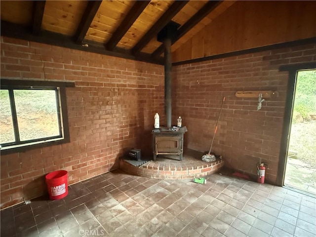 5755 Boulder Creek Rd, Julian, CA 92036 - detailed view of a wood ceiling with exposed beams, a wood stove, and brick wall