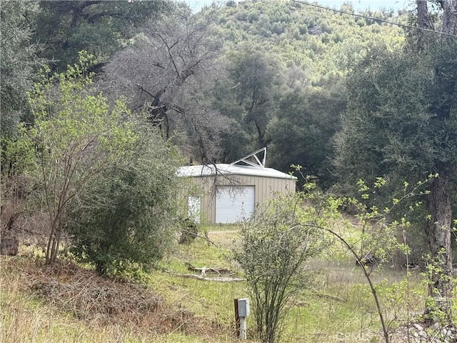 5755 Boulder Creek Rd, Julian, CA 92036 - view of yard with a forest view, a garage, and an outbuilding