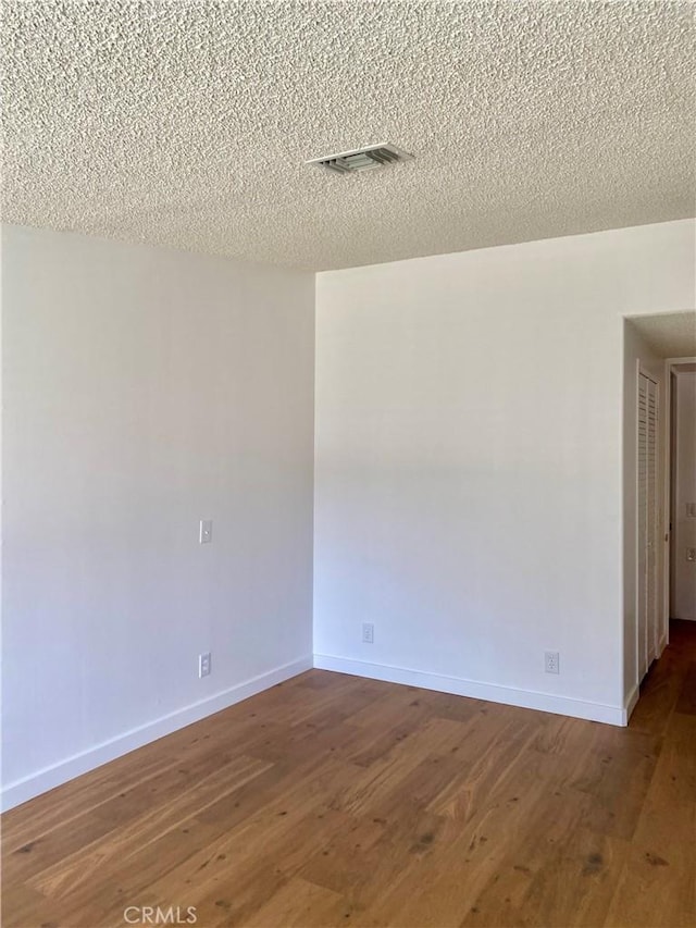 1830 Sunningdale Rd Unit M14-G, Seal Beach, CA 90740 - spare room featuring wood finished floors and a textured ceiling