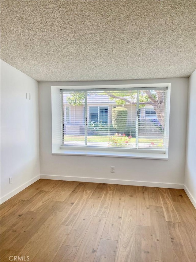 1830 Sunningdale Rd Unit M14-G, Seal Beach, CA 90740 - empty room with a textured ceiling, light wood-style floors, and plenty of natural light