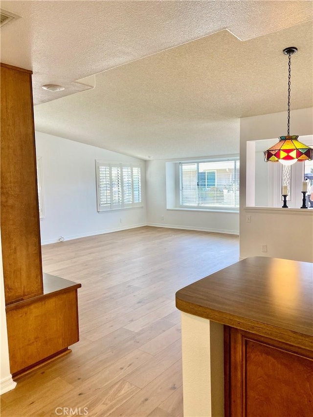 1830 Sunningdale Rd Unit M14-G, Seal Beach, CA 90740 - unfurnished living room with a textured ceiling and light wood-style flooring