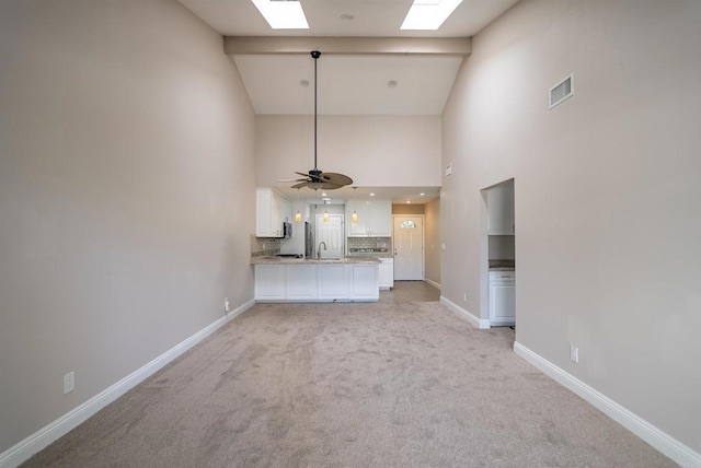 7000 Saranac St Unit 54, La Mesa, CA 91942 - unfurnished living room featuring high vaulted ceiling, a skylight, light carpet, and ceiling fan