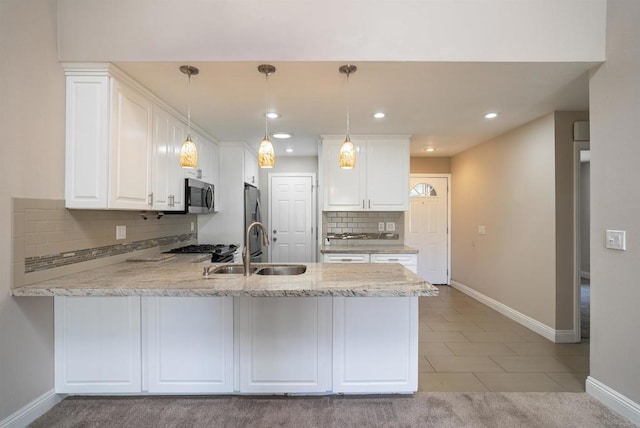 7000 Saranac St Unit 54, La Mesa, CA 91942 - kitchen with appliances with stainless steel finishes, a peninsula, tasteful backsplash, white cabinets, and recessed lighting