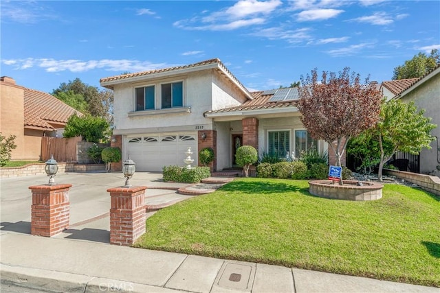 2252 Verbena Ave, Upland, CA 91784 - view of front of house featuring an attached garage, roof mounted solar panels, a tiled roof, concrete driveway, and stucco siding