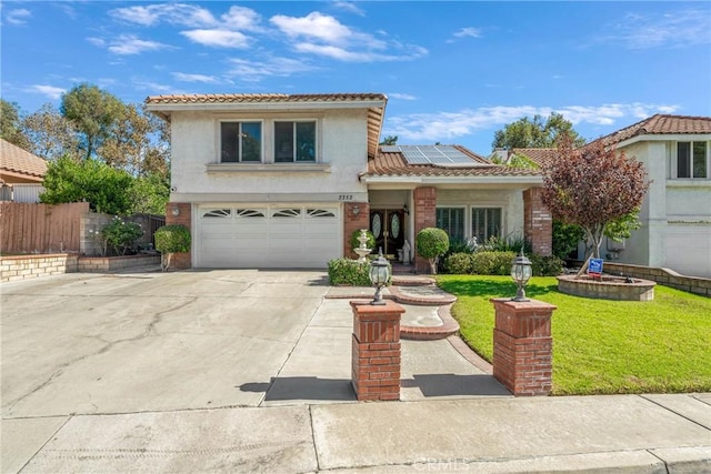 2252 Verbena Ave, Upland, CA 91784 - view of front of house with driveway, a tile roof, an attached garage, roof mounted solar panels, and stucco siding