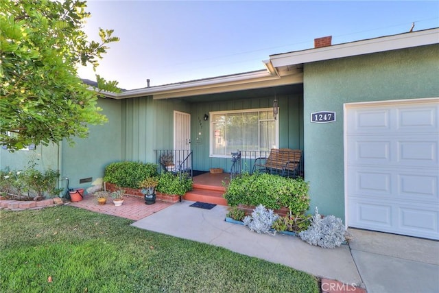 1247 E Marbury St, West Covina, CA 91790 - property entrance featuring covered porch, a garage, a yard, stucco siding, and a chimney