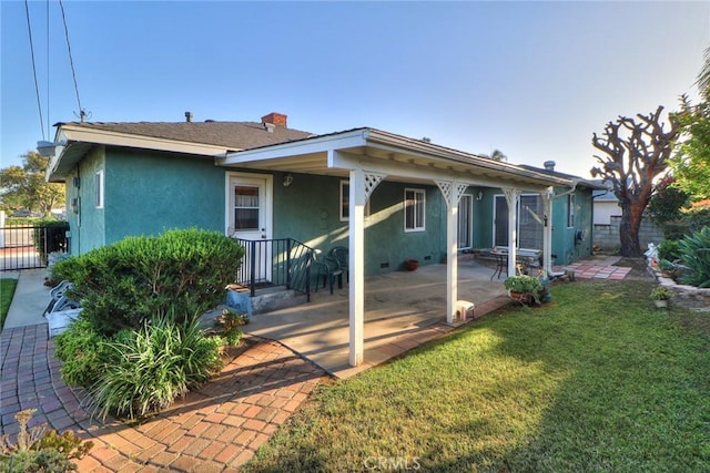 1247 E Marbury St, West Covina, CA 91790 - rear view of house featuring stucco siding, a chimney, and a patio