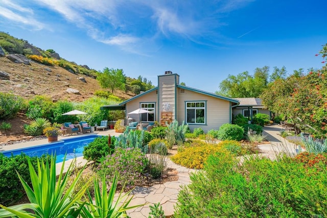 23007 Arjo Ln, Ramona, CA 92065 - back of house with an outdoor pool, a chimney, and a patio area