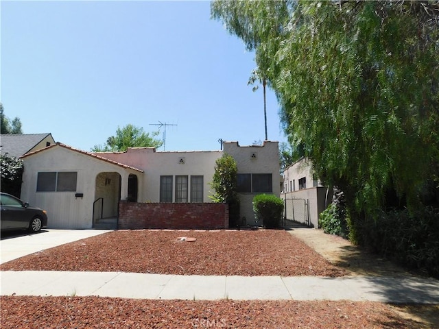 10852 Otsego St, North Hollywood, CA 91601 - mediterranean / spanish-style house featuring a gate and stucco siding