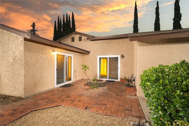 173 Butler Ct, Claremont, CA 91711 - view of exterior entry featuring stucco siding and a patio area