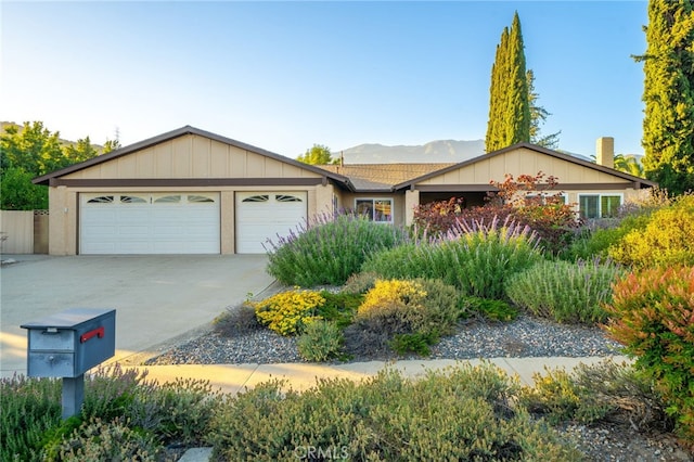 173 Butler Ct, Claremont, CA 91711 - ranch-style home with an attached garage, concrete driveway, board and batten siding, and a mountain view