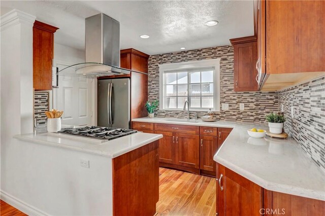6232 Richmond Ave, Garden Grove, CA 92845 - kitchen with stainless steel appliances, light wood-style flooring, island exhaust hood, backsplash, and recessed lighting