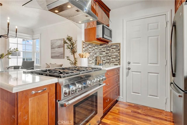 6232 Richmond Ave, Garden Grove, CA 92845 - kitchen featuring stainless steel appliances, brown cabinetry, light wood-style flooring, light countertops, and ornamental molding