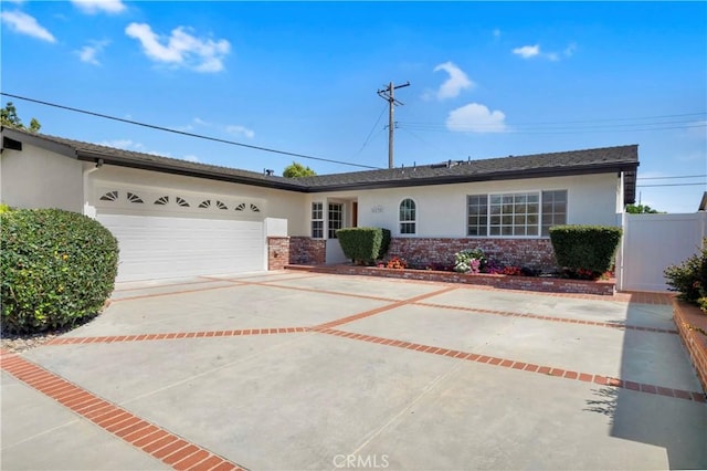6232 Richmond Ave, Garden Grove, CA 92845 - ranch-style house featuring stucco siding, an attached garage, concrete driveway, and brick siding