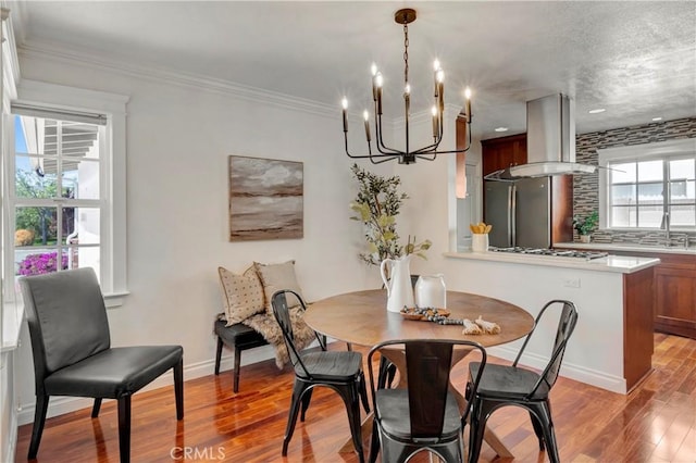 6232 Richmond Ave, Garden Grove, CA 92845 - dining space featuring a chandelier, light wood-type flooring, and crown molding