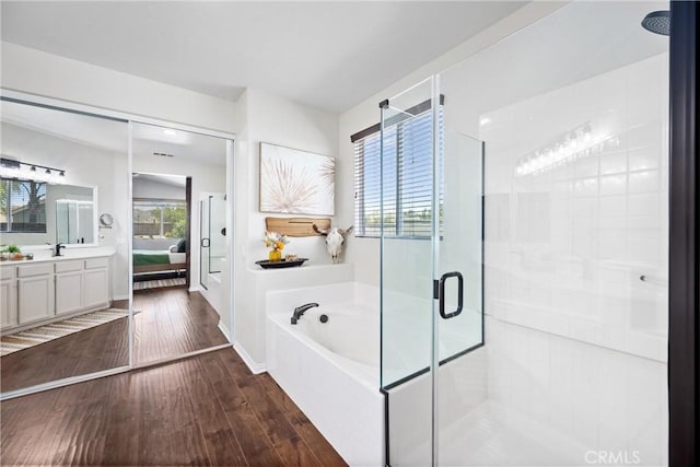 19205 Sterling Hill Ln, Perris, CA 92570 - full bath featuring a stall shower, a bath, wood finished floors, vanity, and ensuite bath