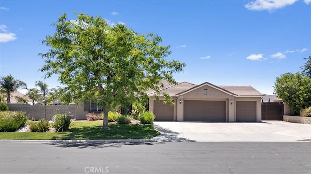 19205 Sterling Hill Ln, Perris, CA 92570 - view of front of property with a garage, stucco siding, a tiled roof, and driveway
