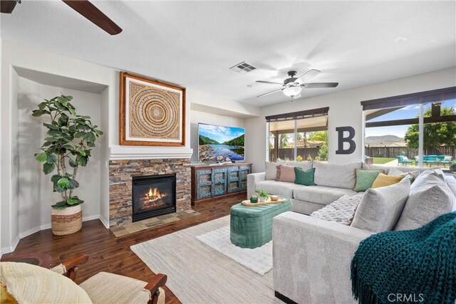 19205 Sterling Hill Ln, Perris, CA 92570 - living area with ceiling fan, wood finished floors, and a stone fireplace