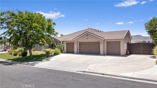 19205 Sterling Hill Ln, Perris, CA 92570 - ranch-style home featuring an attached garage, stucco siding, concrete driveway, a tile roof, and a mountain view