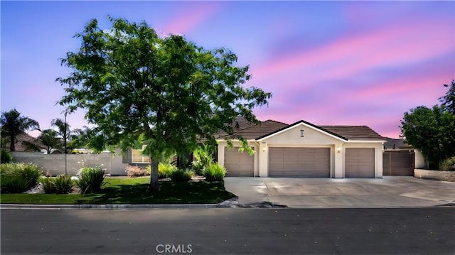 19205 Sterling Hill Ln, Perris, CA 92570 - view of front facade with a garage, a tile roof, concrete driveway, and stucco siding