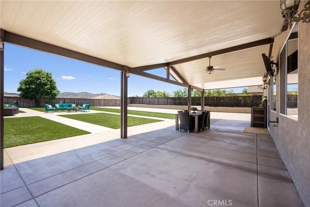 19205 Sterling Hill Ln, Perris, CA 92570 - fenced backyard with an outdoor living space, a patio, and ceiling fan