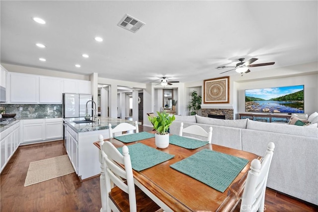 19205 Sterling Hill Ln, Perris, CA 92570 - dining room with a ceiling fan, dark wood-style floors, recessed lighting, and a fireplace