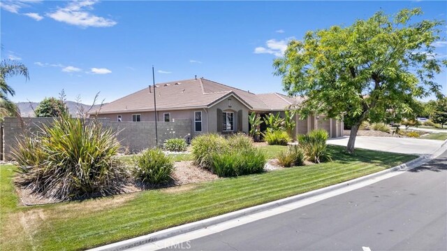 19205 Sterling Hill Ln, Perris, CA 92570 - view of front of property featuring stucco siding, a garage, a tile roof, and driveway