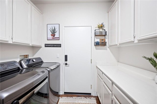 19205 Sterling Hill Ln, Perris, CA 92570 - laundry room featuring washing machine and dryer, cabinet space, and wood finished floors