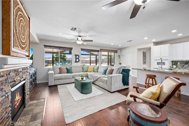 19205 Sterling Hill Ln, Perris, CA 92570 - living room with ceiling fan, recessed lighting, a fireplace, and dark wood finished floors