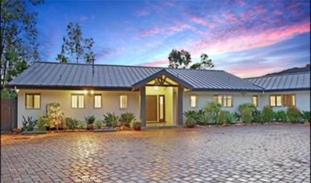 24311 Sylvan Glen Rd, Calabasas, CA 91302 - single story home with a standing seam roof, a metal roof, and stucco siding