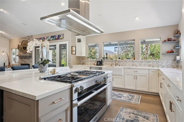 24311 Sylvan Glen Rd, Calabasas, CA 91302 - kitchen featuring double oven range, exhaust hood, plenty of natural light, a kitchen island, and recessed lighting