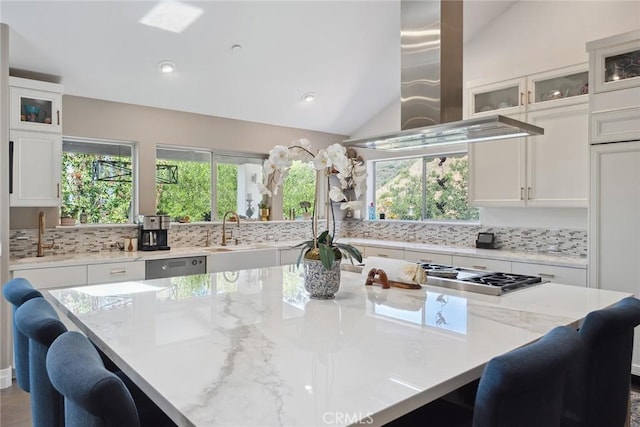 24311 Sylvan Glen Rd, Calabasas, CA 91302 - kitchen with backsplash, a kitchen breakfast bar, white cabinetry, healthy amount of natural light, and lofted ceiling