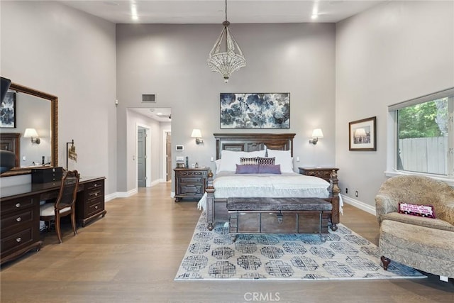 24311 Sylvan Glen Rd, Calabasas, CA 91302 - bedroom with a high ceiling, a desk, and wood finished floors