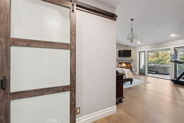 24311 Sylvan Glen Rd, Calabasas, CA 91302 - corridor with wood finished floors and a barn door